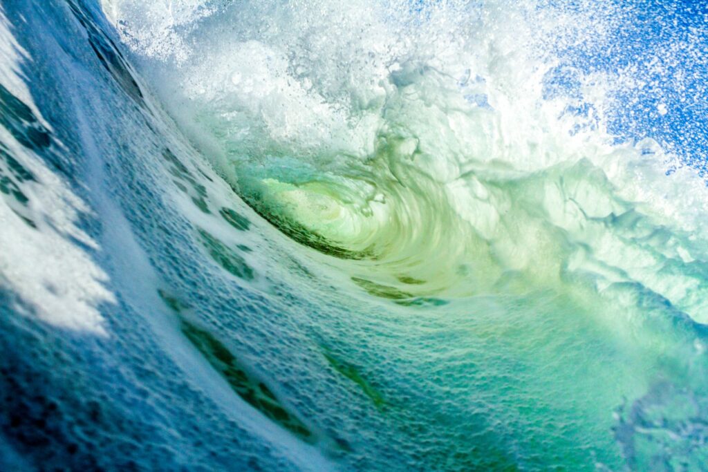 Vibrant ocean wave curling with frothy water.