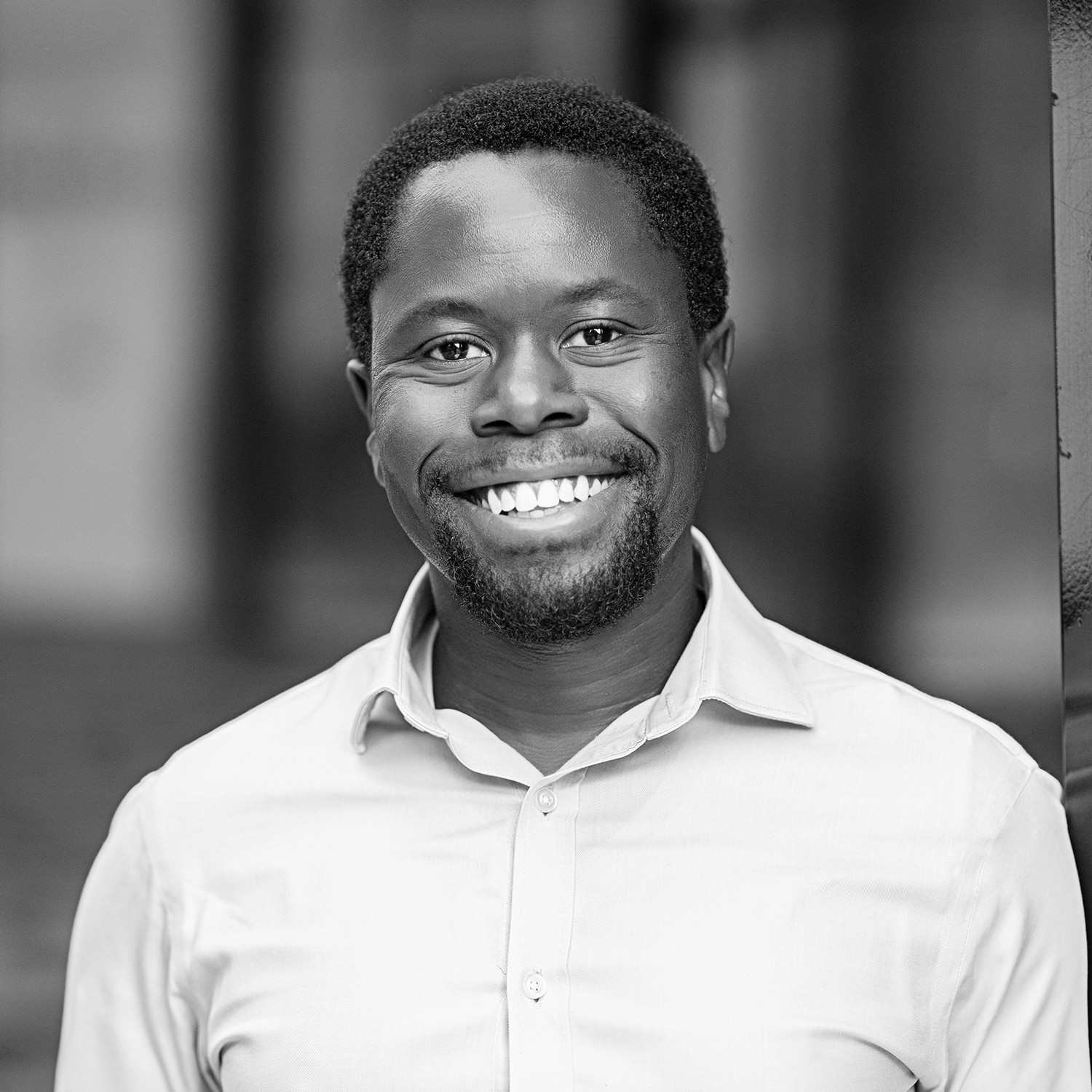 Black and white formal headshot of Iyobosa Adeghe.